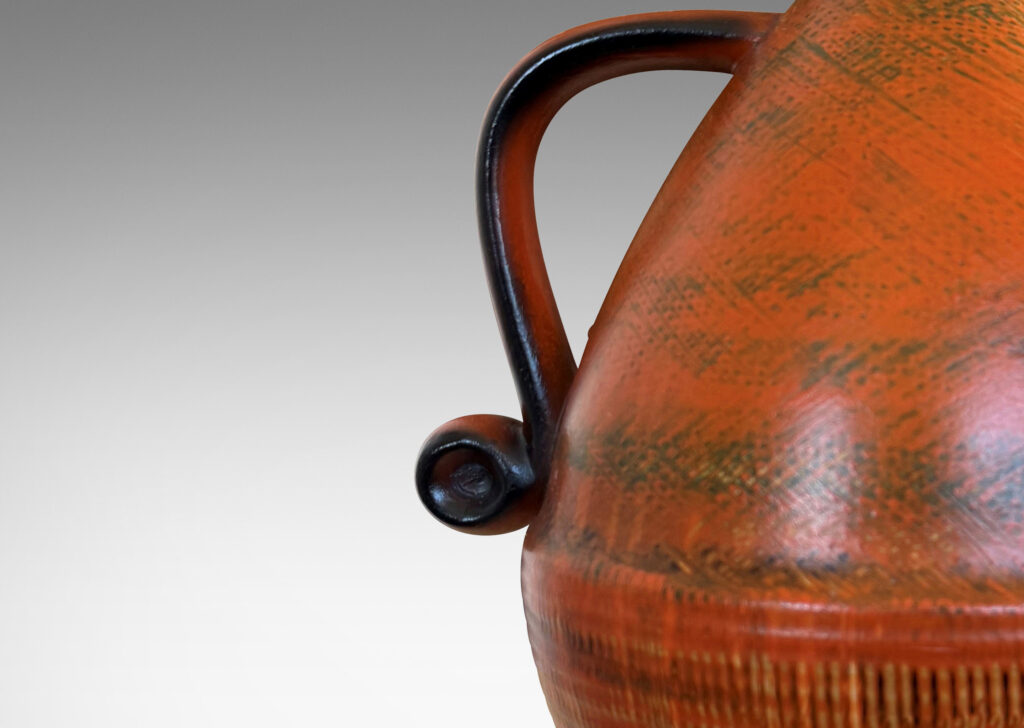 Gallery BAC upturned acorn form on a flared foot with scroll handles, glazed in brush textured orange and black
