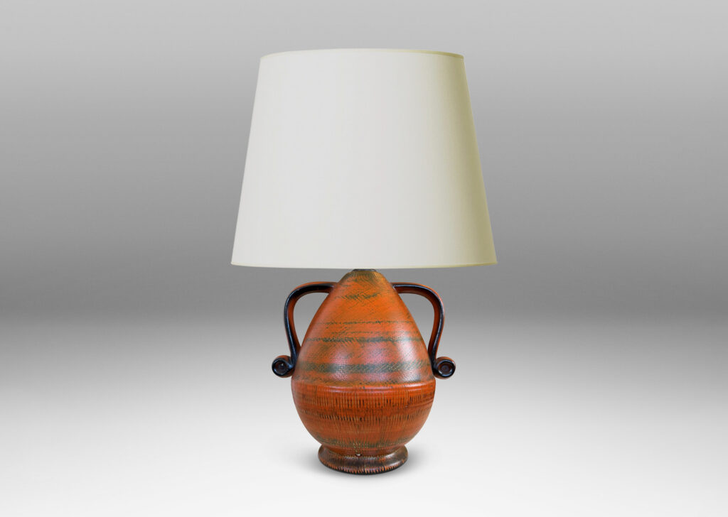 Gallery BAC upturned acorn form on a flared foot with scroll handles, glazed in brush textured orange and black