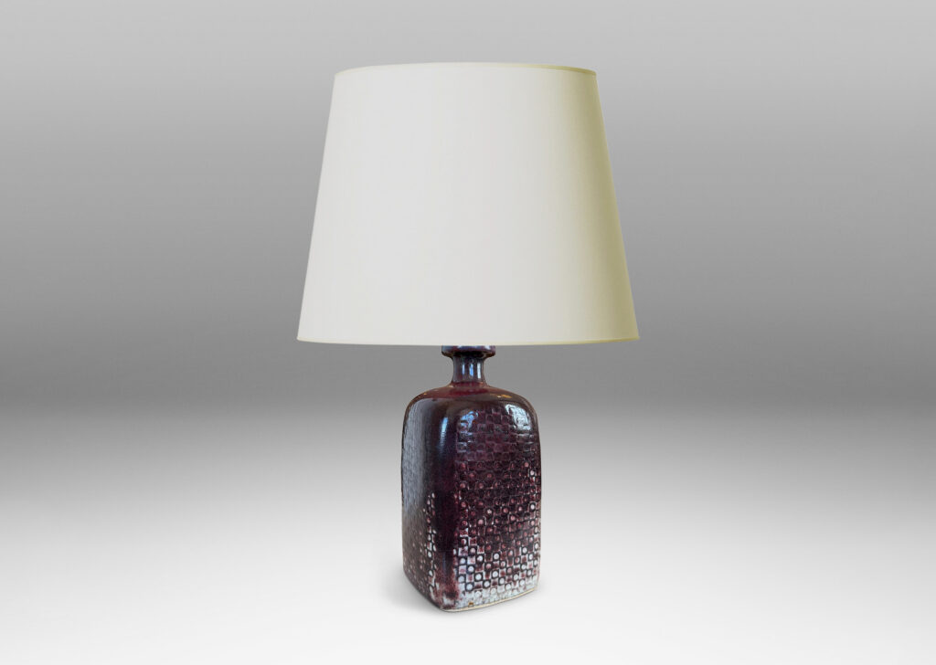 Gallery BAC tall squared bottle-like form with impressed checker circle-square pattern, glazed in flowing oxblood burgundy