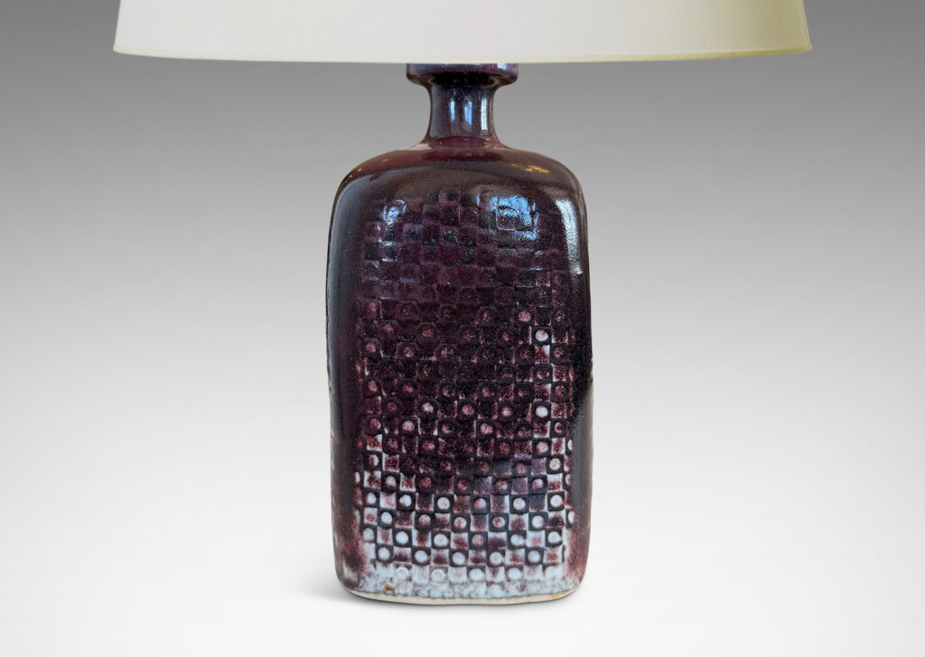 Gallery BAC tall squared bottle-like form with impressed checker circle-square pattern, glazed in flowing oxblood burgundy