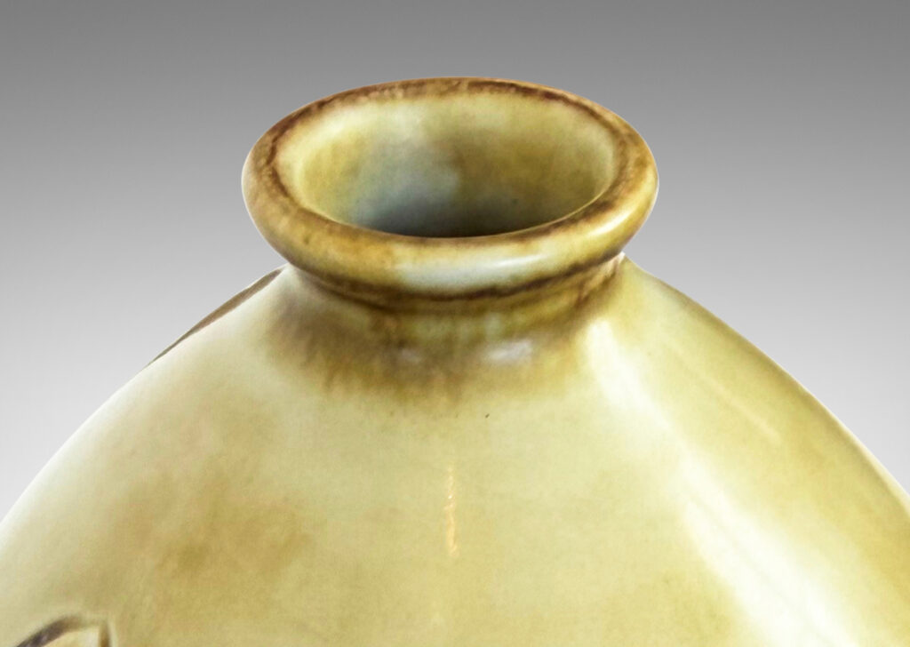 Gallery BAC drop form with carved reliefs of goldfish and water flora, glazed in a thin amber-tan with brown accents