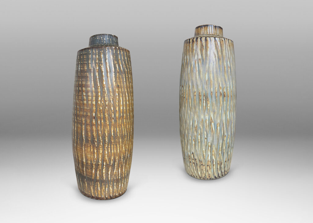Gallery BAC large swelling cylinder forms with cuff necks, finished with a carved texture and flowing brown glaze over gray