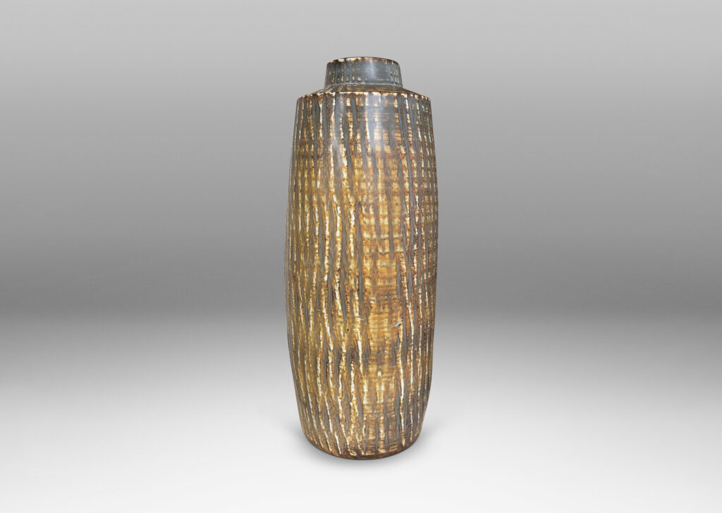 Gallery BAC large swelling cylinder forms with cuff necks, finished with a carved texture and flowing brown glaze over gray