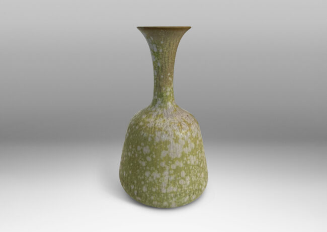 Gallery BAC angled form with delicate trumpeting neck and mouth, glazed in a dappled pale green
