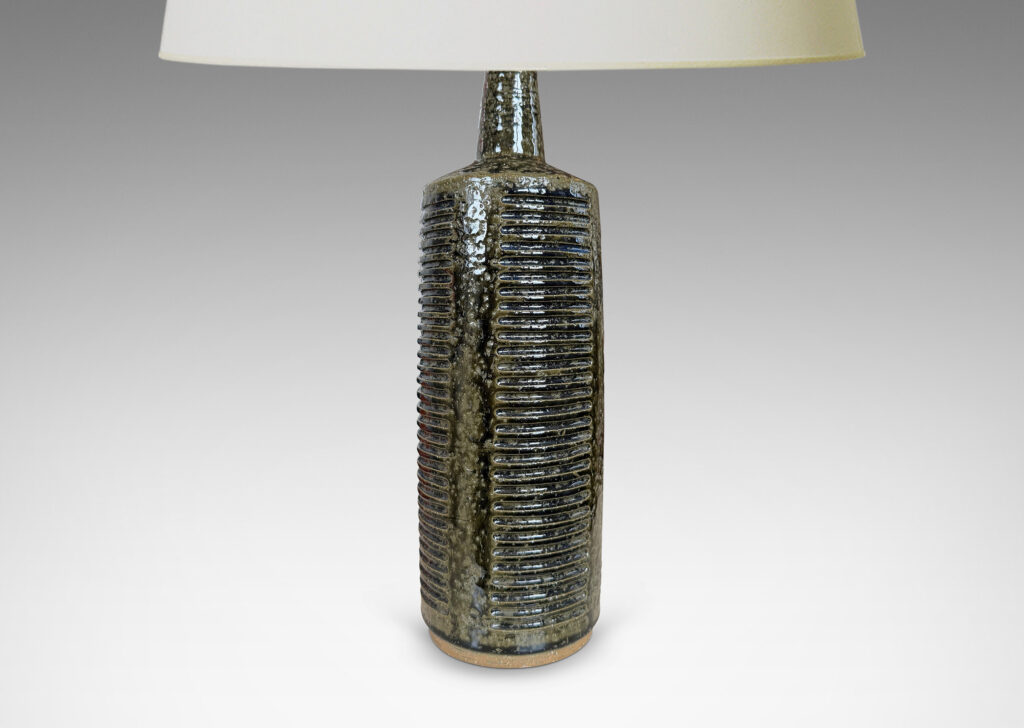 Gallery BAC cylindrical form with columns of carved lines and tall conical neck, glazed in a shiny dark mossy green