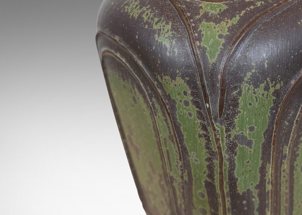 Gallery BAC four arched sides with squinched shoulders and a bottle mouth, glazed in eggshell jungle green and brown