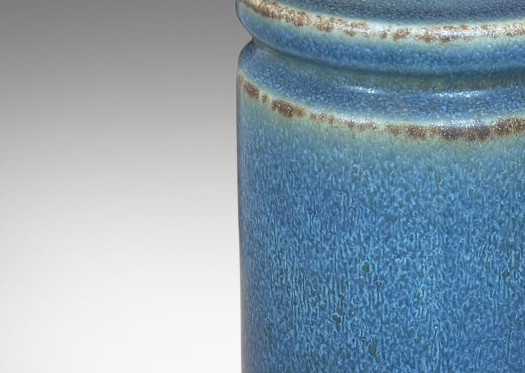 Gallery BAC cylindrical forms with exotic capped top, glazed in a soft blue with brown