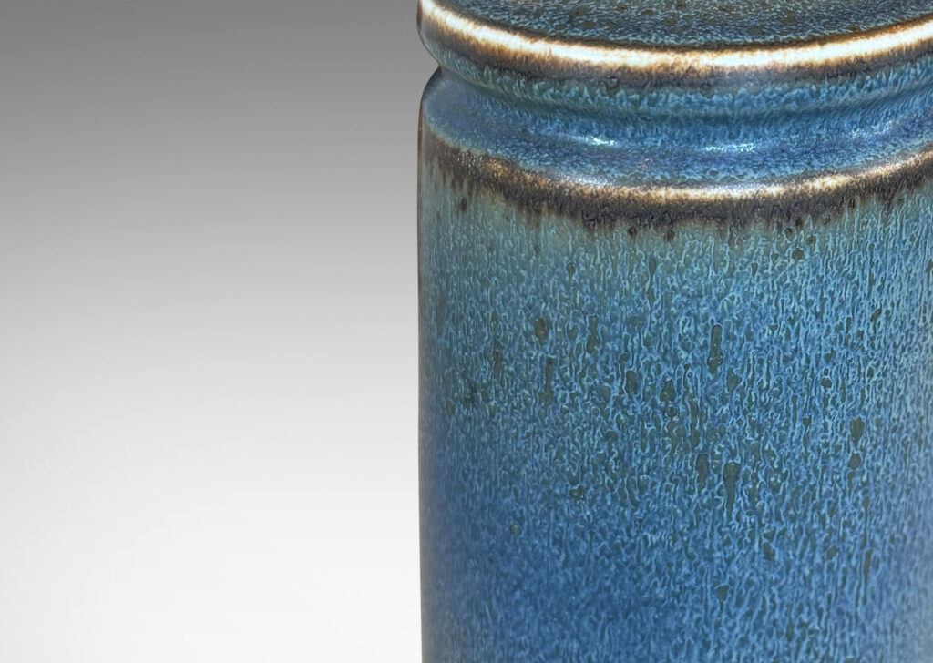 Gallery BAC cylindrical forms with exotic capped top, glazed in a soft blue with brown