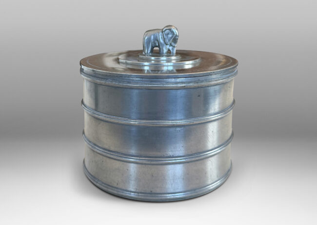 Gallery BAC cylindrical form encircled with ridged bands, and a lid with elephant finial