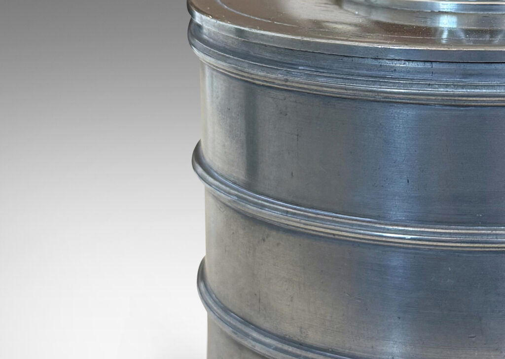 Gallery BAC cylindrical form encircled with ridged bands, and a lid with elephant finial