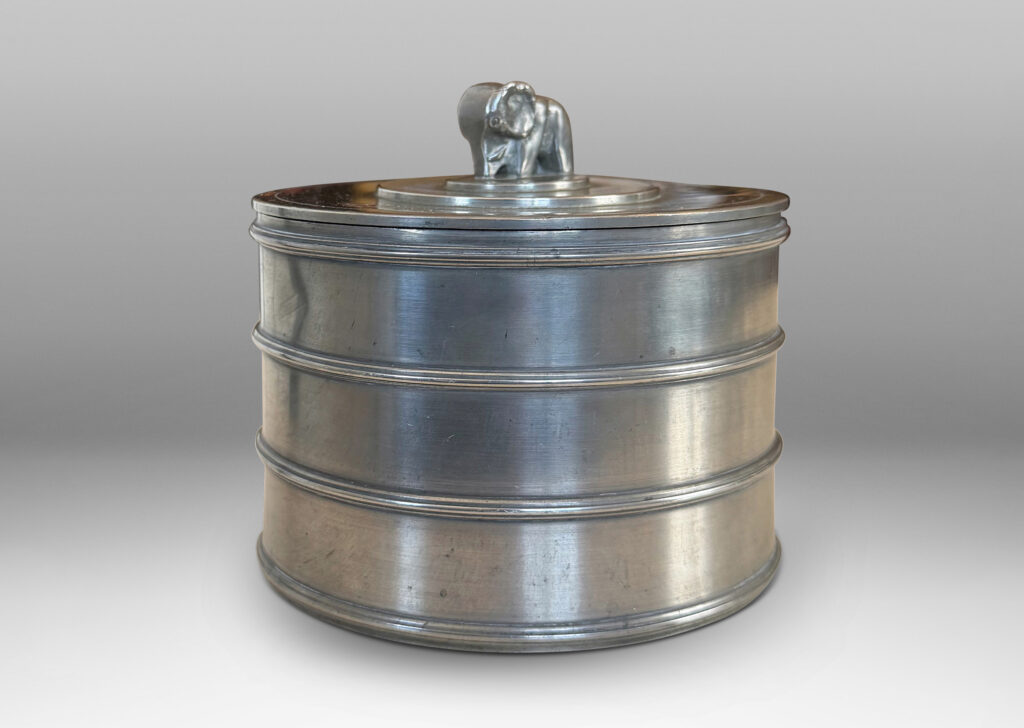 Gallery BAC cylindrical form encircled with ridged bands, and a lid with elephant finial