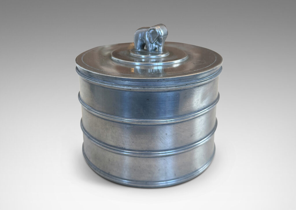 Gallery BAC cylindrical form encircled with ridged bands, and a lid with elephant finial