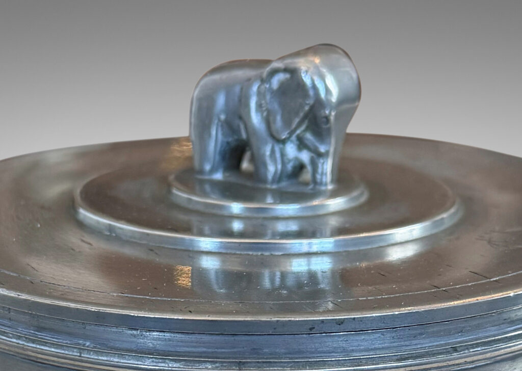 Gallery BAC cylindrical form encircled with ridged bands, and a lid with elephant finial