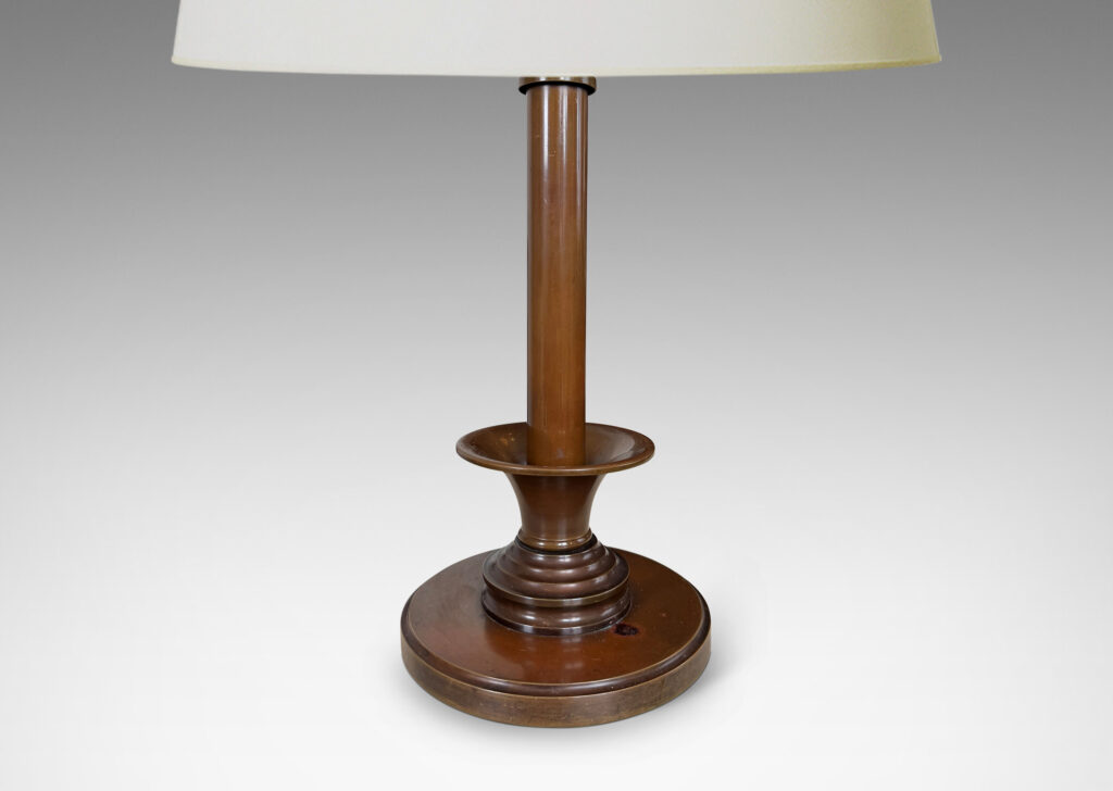 Gallery BAC disk plinth and muscular stand, with trumpeting fob on a ridged base, featuring a fine, warm brown