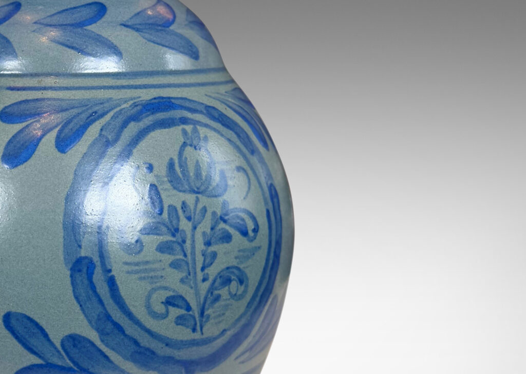 Gallery BAC plump baluster form glazed in light blue, with hand-painted blue foliate ornaments